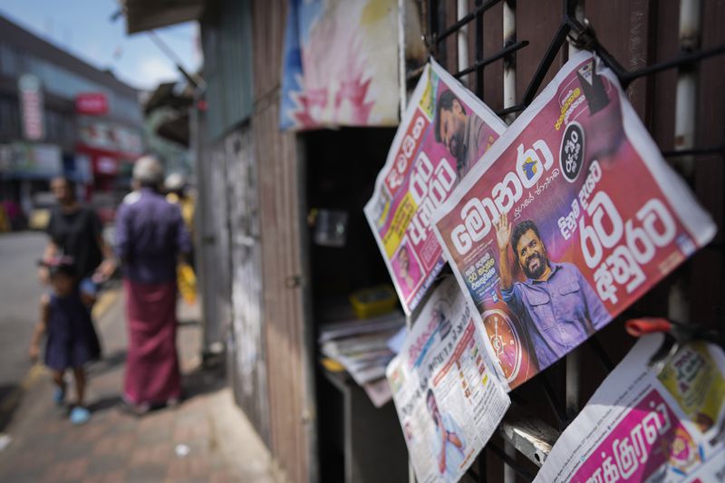 Newspapers with headlines about the new president elect Marxist lawmaker Anura Kumara Dissanayake are on display in Colombo, Sri Lanka, Monday, Sept. 23, 2024. (AP Photo/Eranga Jayawardena)