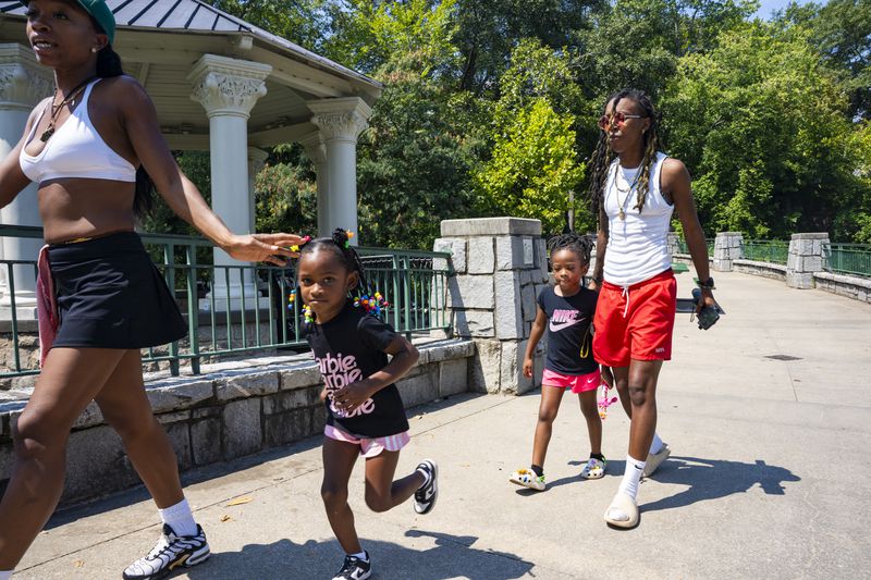 A family shows up for the Pure Heat Community Festival in Piedmont Park on Sunday, Sept. 1, 2024.  (Olivia Bowdoin for the AJC). 