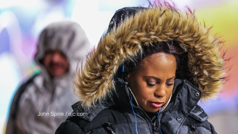 Eva Harden braves the cold at the Northside MARTA transit station early Tuesday. JOHN SPINK / JSPINK@AJC.COM
