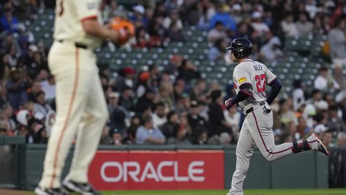 Atlanta Braves' Austin Riley, right, runs the bases after hitting a solo home run against San Francisco Giants pitcher Erik Miller, foreground, during the fifth inning of a baseball game, Wednesday, Aug. 14, 2024, in San Francisco. (AP Photo/Godofredo A. Vásquez)