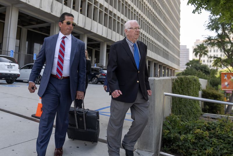 Orange County Superior Court Judge Jeffrey Ferguson, right, walks out of court with his attorney T. Edward Welbourn, after attending a preliminary hearing in Los Angeles, Thursday, June 20, 2024. (AP Photo/Damian Dovarganes)