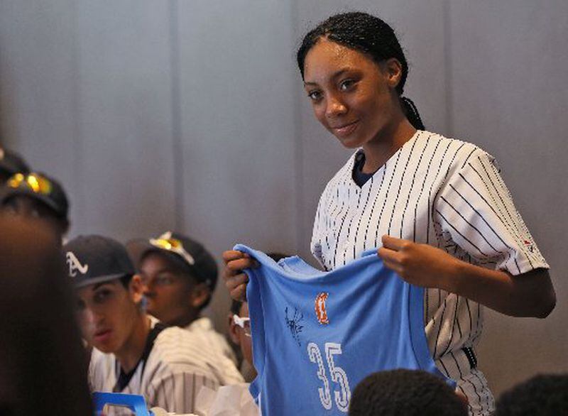Mo’ne Davis, a pitcher with the Anderson Monarchs and one of the few black girls to play on a boy’s team, receives a jersey from Angela Taylor, president and general manager of the WNBA Atlanta Dream at the National Center for Civil and Human Rights. Davis pitches for the Anderson Monarchs, a little league team based in Philadelphia, which is making a 23-day civil rights tour. BOB ANDRES / BANDRES@AJC.COM