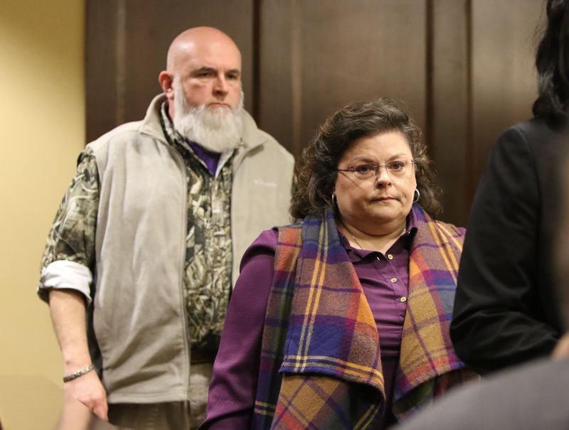 Mark (left) and Lori Hicks, parents of Matthew Hicks, walk back to their seat after speaking Friday during Jacob Kosky's plea and sentencing hearing. EMILY HANEY / emily.haney@ajc.com