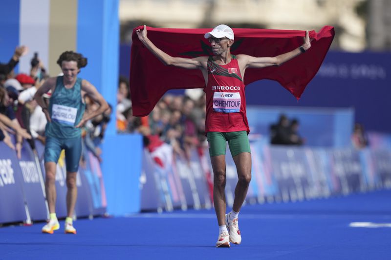 Bronze medalist El Amin Shantof of Morocco celebrates his victory in the men's marathon T12 at the 2024 Paralympic Games in Paris, France, Sunday, Sept. 8, 2024. (AP Photo/Thibault Camus)