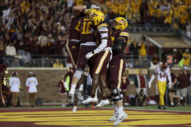 Minnesota celebrates a touchdown by quarterback Max Brosmer (16) during the second half of an NCAA college football game against Southern California, Saturday, Oct. 5, 2024, in Minneapolis. (AP Photo/Ellen Schmidt)