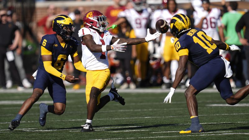 Michigan defensive back Zeke Berry (10) breaks up a pass intended for Southern California wide receiver Zachariah Branch (1) as Brandyn Hillman (6) looks on in the first half of an NCAA college football game in Ann Arbor, Mich., Saturday, Sept. 21, 2024. (AP Photo/Paul Sancya)