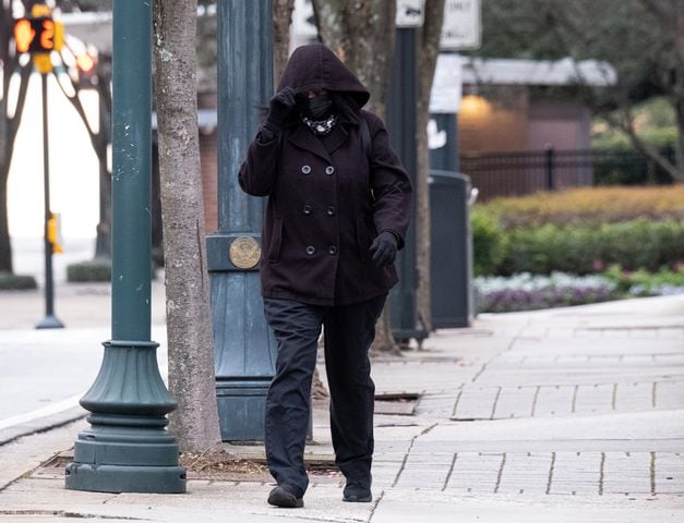 The holiday weekend came to end with cold temperatures in the city hovering around freezing all day. A woman makes her way to work in Midtown despite the cold and windy conditions Monday morning, January 17, 2022. (Photo: Ben Gray for The Atlanta Journal-Constitution)