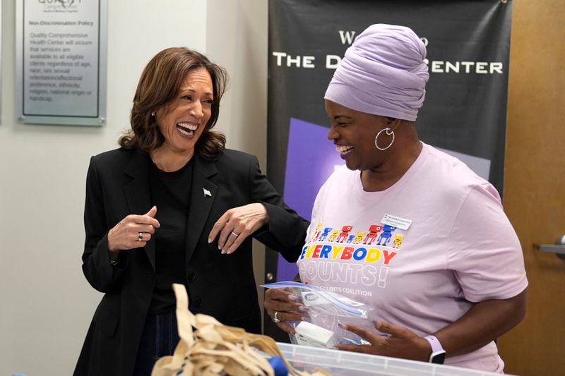 Democratic presidential nominee Vice President Kamala Harris, left, greets a worker at a food drop-off and distribution center after receiving a briefing on the damage from Hurricane Helene, Saturday, October 5, 2024, in Charlotte, N.C. (AP Photo/Chris Carlson)