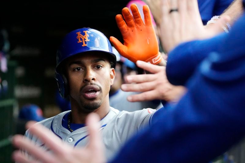 New York Mets' Francisco Lindor celebrates with teammates after hitting a two-run home run during the third inning of a baseball game against the Chicago Cubs in Chicago, Sunday, June 23, 2024. (AP Photo/Nam Y. Huh)