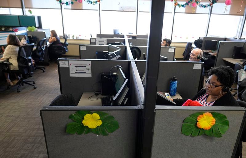 Customer Experience Representative Cassia Jones-Woodard, right, and other representatives take calls at an Alorica center, Monday, Aug. 19, 2024, in San Antonio. (AP Photo/Eric Gay)