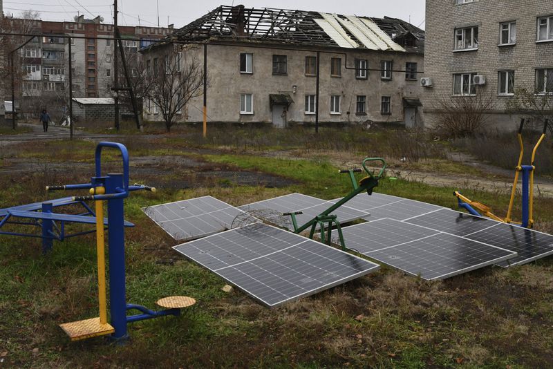 FILE - Solar panels lay in the yard of an apartment building in Lyman, Donetsk region, Ukraine, Sunday, Nov. 20, 2022. (AP Photo/Andriy Andriyenko, File)