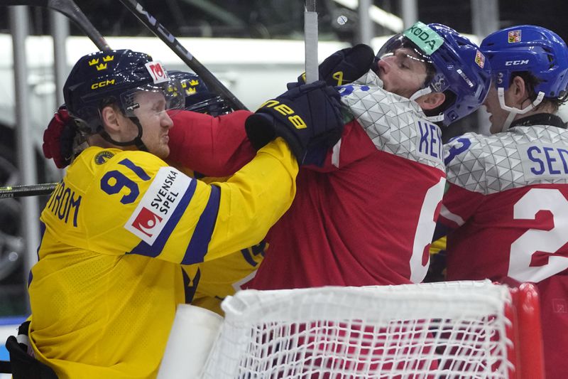 Sweden's Carl Grundstrom, left, fights with Czech Republic's Michal Kempny during the semifinal match between Czech Republic and Sweden at the Ice Hockey World Championships in Prague, Czech Republic, Saturday, May 25, 2024. (AP Photo/Petr David Josek)
