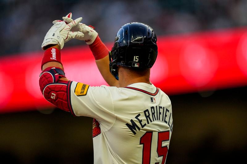 Atlanta Braves outfielder Whit Merrifield (15) celebrates his triple against the Philadelphia Phillies during the third inning of a baseball game, Tuesday, Aug. 20, 2024, in Atlanta. (AP Photo/Mike Stewart)