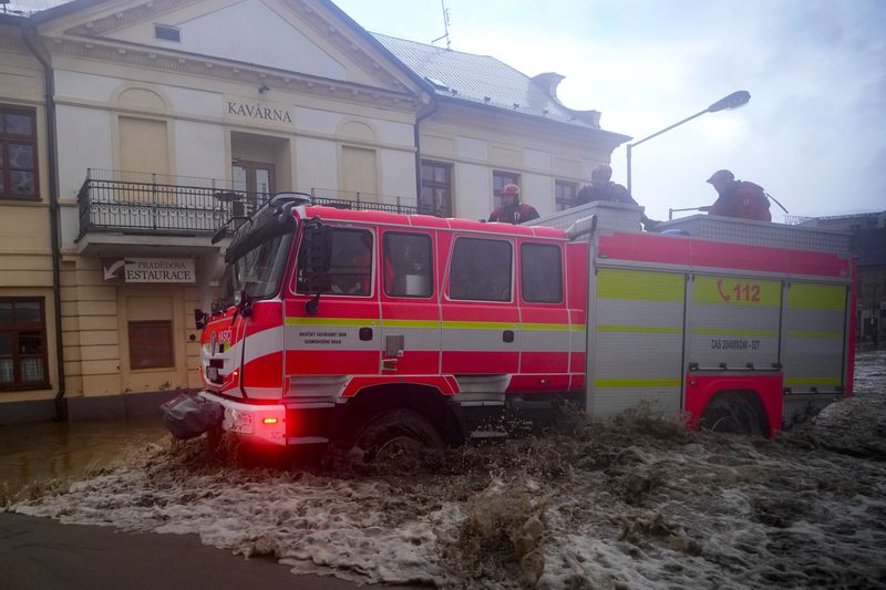 Firemen drive through flooded streets of Jesenik, Czech Republic, Sunday, Sept. 15, 2024. (AP Photo/Petr David Josek)