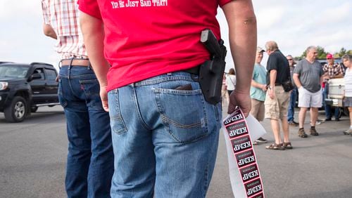 10/01/2018 -- Jasper, Georgia -- An Appalachian Gun, Pawn & Range employee hands out Brain Kemp campaign stickers during a campaign stop in Jasper, Monday, October 1, 2018. Monday was the first day of Brian Kemp's weeklong bus tour where he and his campaign will visit 27 counties in 5 days. (ALYSSA POINTER/ALYSSA.POINTER@AJC.COM)