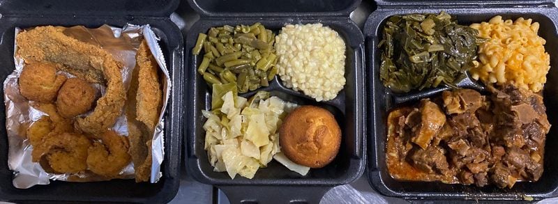 Who’s Got Soul Southern Cafe takeout includes a seafood platter with catfish, whiting, shrimp and hushpuppies; a vegetable plate with green beans, corn, cabbage and a corn muffin; and oxtails over rice with macaroni and cheese and collards. 
Wendell Brock for The Atlanta Journal-Constitution