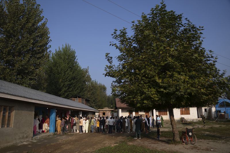 Kashmiri's queue up at a polling booth to cast their vote during the second phase of the assembly election in the outskirts of Srinagar, Indian controlled Kashmir, Wednesday, Sept. 25, 2024. (AP Photo/Dar Yasin)