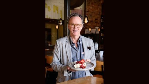 Rob Gentry, the owner of Hey Monty in Chattanooga, holds a slice of his no-bake MoonPie cheesecake. / Photo by Mark Gilliland