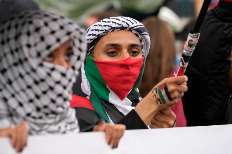 Women attend at a protest in Rome, Saturday, Oct. 5, 2024. Pro-palestinians people take to the street in an unauthorised march in the centre of Rome two days ahead of the first anniversary of the Oct. 7. (AP Photo/Andrew Medichini)