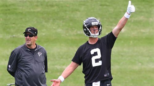 June 5, 2018 Flowery Branch: Atlanta Falcons quarterback Matt Ryan gives the thumbs up after completing a pass to Mohamed Sanu with Greg Knapp looking on during organized team activity on Tuesday, June 5, 2018, in Flowery Branch.  Curtis Compton/ccompton@ajc.com