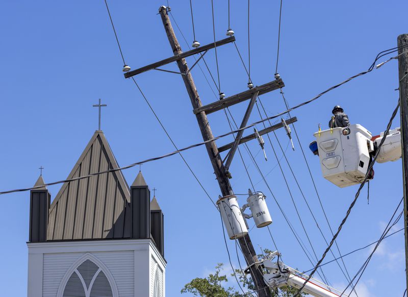 City of Tallahassee, Florida utility crews help straighten a utility pole s damaged by Hurricane Francine Thursday, Sept. 12, 2024, in downtown Houma, La. (Chris Granger/The Times-Picayune/The New Orleans Advocate via AP)