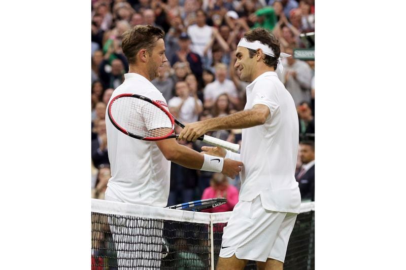 FILE - Roger Federer of Switzerland shakes hands with Marcus Willis of Britain, left, after beating him in their men's singles match on day three of the Wimbledon Tennis Championships in London, Wednesday, June 29, 2016. Willis, the Everyman's everyman who faced Roger Federer at Centre Court while ranked 772nd in 2016, was back at Wimbledon on Thursday, July 4, 2024, competing in men's doubles and hoping he might get to have a bit of a reunion with the now-retired eight-time champion at the All England Club.(AP Photo/Tim Ireland, File)