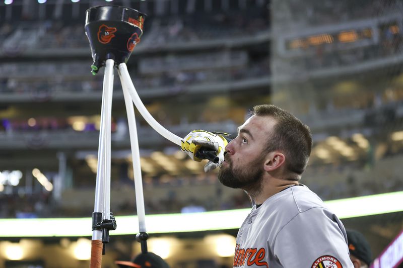 Baltimore Orioles' Colton Cowser celebrates after his solo home run during the seventh inning of a baseball game against the Minnesota Twins, Friday, Sept. 27, 2024, in Minneapolis. (AP Photo/Matt Krohn)