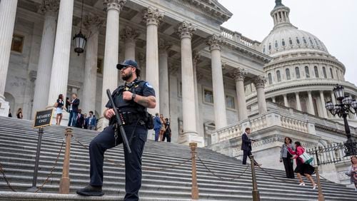 A U.S. Capitol Police officer stands watch as lawmakers leave the House of Representatives after voting on an interim spending bill to avoid a government shutdown next week, at the Capitol in Washington, Wednesday, Sept. 25, 2024. (AP Photo/J. Scott Applewhite)