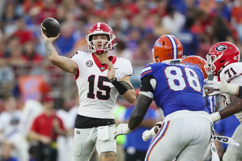 Georgia quarterback Carson Beck (15) attempts a pass against Florida defensive lineman Caleb Banks (88) during the fourth quarter at EverBank Stadium, Saturday, October 27, 2023, in Jacksonville, Fl. Georgia won 43-20 against Florida. (Jason Getz / Jason.Getz@ajc.com)