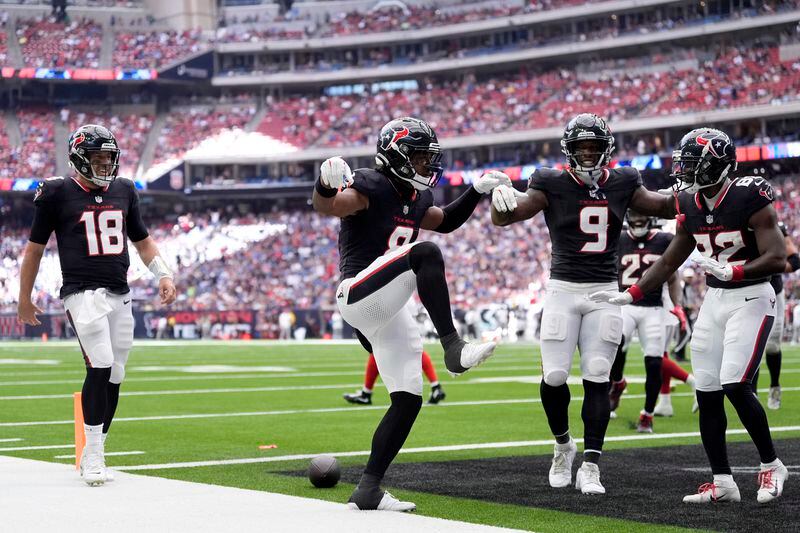 Houston Texans wide receiver John Metchie III, center, celebrates his touchdown catch thrown by quarterback Case Keenum (18) as Brevin Jordan (9) and Steven Sims (82) look on in the first half of a preseason NFL football game against the New York Giants, Saturday, Aug. 17, 2024, in Houston. (AP Photo/Eric Gay)