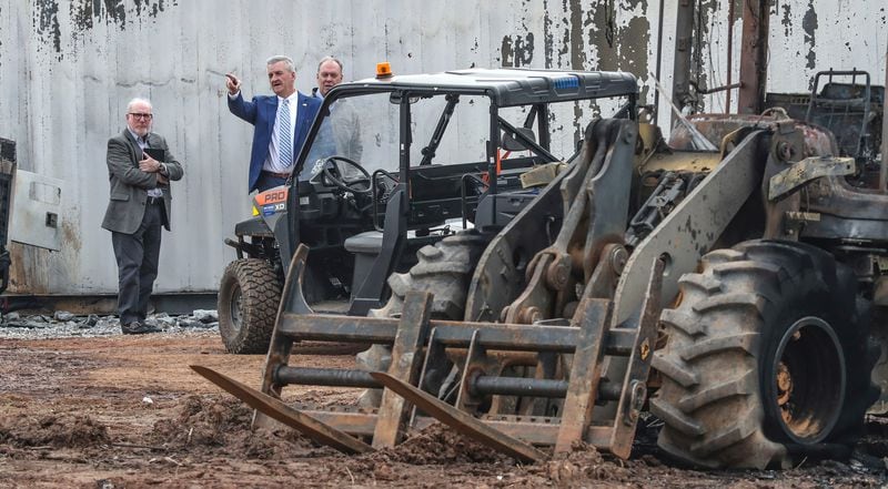 Dave Wilkinson, president and CEO of the Atlanta Police Foundation (second from left) joined Atlanta police and construction personnel to examine the site of the police training center on Monday, after violent protests on Sunday. (John Spink/The Atlanta Journal-Constitution/TNS)