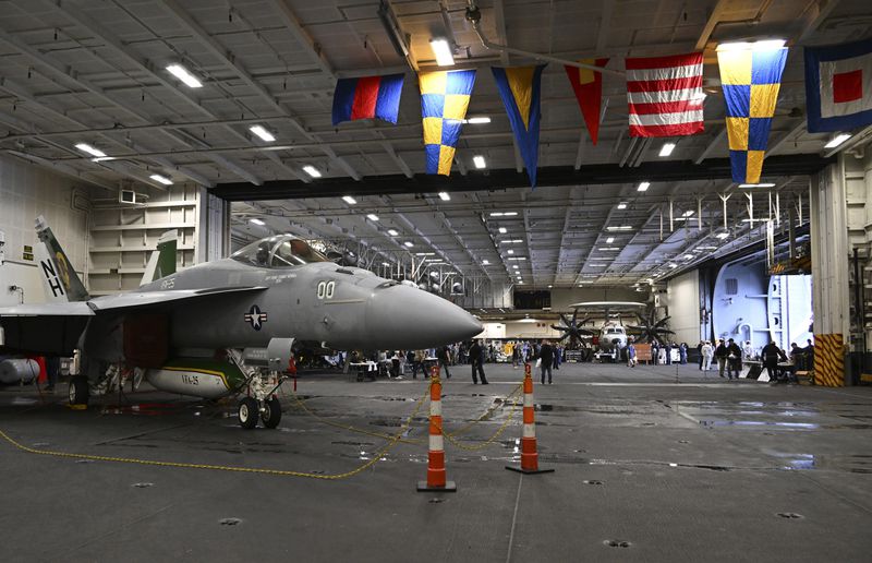 An F-18 fighter aircraft sits in the hanger of the Theodore Roosevelt (CVN 71), a nuclear-powered aircraft carrier, anchored in Busan Naval Base in Busan, South Korea Saturday, June 22, 2024. (Song Kyung-Seok/Pool Photo via AP)