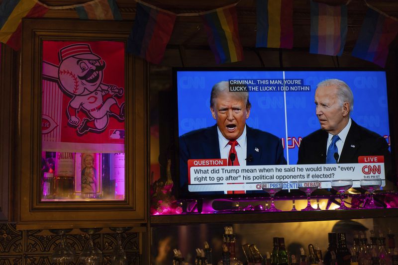 President Joe Biden, right, and Republican presidential candidate former President Donald Trump, left, are seen on a television at Tillie's Lounge during the presidential debate on Thursday, June 27, 2024, in Cincinnati. For many voters in the U.S., there's despair in the air after the presidential debate this past week. (AP Photo/Carolyn Kaster)