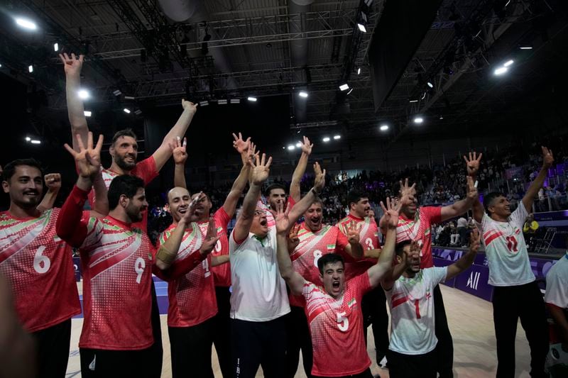 Iran players celebrate after winning the men's Sitting Volleyball Gold Medal Match against Bosnia and Herzegovina, at the 2024 Paralympics, Friday, Sept. 6, 2024, in Paris, France. (AP Photo/Christophe Ena)