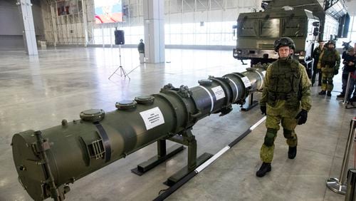 FILE - A Russian military officer walks past the 9M729 land-based cruise missile on display in Kubinka outside Moscow, Russia, on Jan. 23, 2019. Russian President Vladimir Putin has called for resuming production of intermediate-range missiles that were banned under a now-scrapped treaty with the US. The Intermediate-Range Nuclear Forces treaty, which banned ground-based missiles with a range of 500-5,500 kilometers (310-3,410 miles) was regarded as an arms control landmark when Soviet leader Mikhail Gorbachev and U.S. President Ronald Reagan signed it in 1988. (AP Photo/Pavel Golovkin, File)