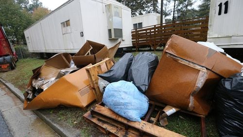 Bags of construction debris from school maintenance work sit stacked up behind classroom trailers at Dekalb County’s Dresden Elementary School on Monday, Nov. 12, 2018, in Chamblee. Curtis Compton/ccompton@ajc.com