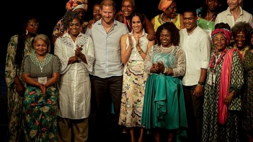 Prince Harry and his wife Meghan pose for a group photo after a forum on Afro women and power in Cali, Colombia, Sunday, Aug. 18, 2024. (AP Photo/Ivan Valencia)