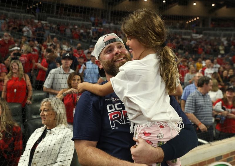 Braves catcher Brian McCann celebrates with his daughter Colbie. (JASON GETZ/SPECIAL TO THE AJC)