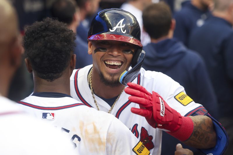 Atlanta Braves shortstop Orlando Arcia (11) celebrates his solo home run with Atlanta Braves second base Ozzie Albies (1) in the dugout during the first inning against the Boston Red Sox at Truist Park, Wednesday, May 8, 2024, in Atlanta.  (Jason Getz / AJC)
