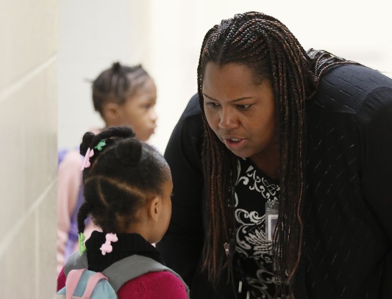 Dione Simon Taylor stops to speak to students during her morning routine.  Bob Andres / robert.andres@ajc.com