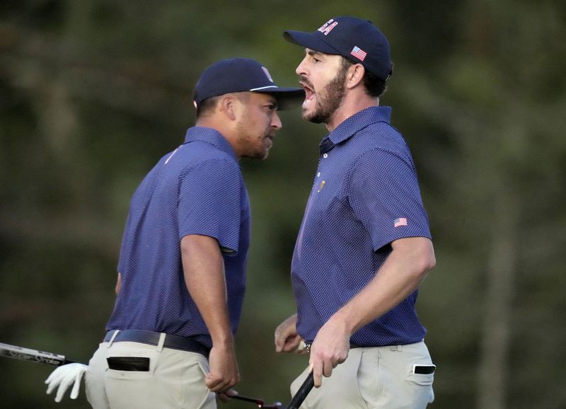 United States team member Patrick Cantlay, right, celebrates with partner Xander Schauffele, left, after winning their fourth-round foursomes match at the Presidents Cup golf tournament at Royal Montreal Golf Club in Montreal, Saturday, Sept. 28, 2024. (Frank Gunn/The Canadian Press via AP)