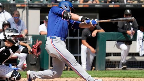 Texas Rangers' Corey Seager hits a solo home run during the fourth inning of a baseball game against the Chicago White Sox in Chicago, Thursday, Aug. 29, 2024. (AP Photo/Nam Y. Huh)