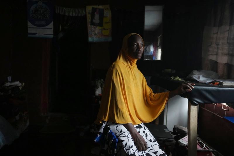 Idowu Bello, 56, poses for a photograph inside her house in Ibadan, Nigeria, Friday, Sept. 13, 2024. (AP Photo/Sunday Alamba)