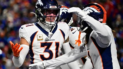 Denver Broncos safety Justin Simmons (31) celebrates his interception of Buffalo Bills quarterback Josh Allen (17) with teammate Tremon Smith (1) in the first quarter at Highmark Stadium Nov. 13, 2023, in Orchard Park, New York. (Andy Cross/The Denver Post/TNS)