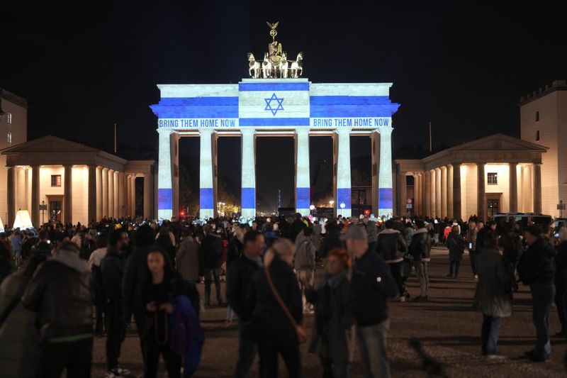 The Brandenburg Gate is illuminated in solidarity with Israel, marking the first anniversary of the Hamas spearheaded attacks on Israel, in Berlin, Germany, Monday, Oct. 7, 2024. (AP Photo/Markus Schreiber)