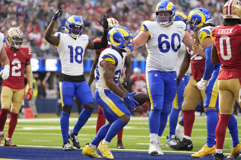 Los Angeles Rams running back Kyren Williams, middle, celebrates after scoring against the San Francisco 49ers during the second half of an NFL football game, Sunday, Sept. 22, 2024, in Inglewood, Calif. (AP Photo/Ashley Landis)