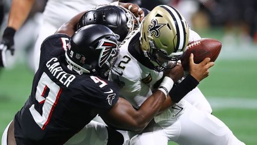 Falcons outside linebacker Lorenzo Carter and defensive lineman Grady Jarrett sack Saints quarterback Jameis Winston for a loss on third down during the second quarter Sunday in Atlanta. (Curtis Compton / Curtis Compton@ajc.com)