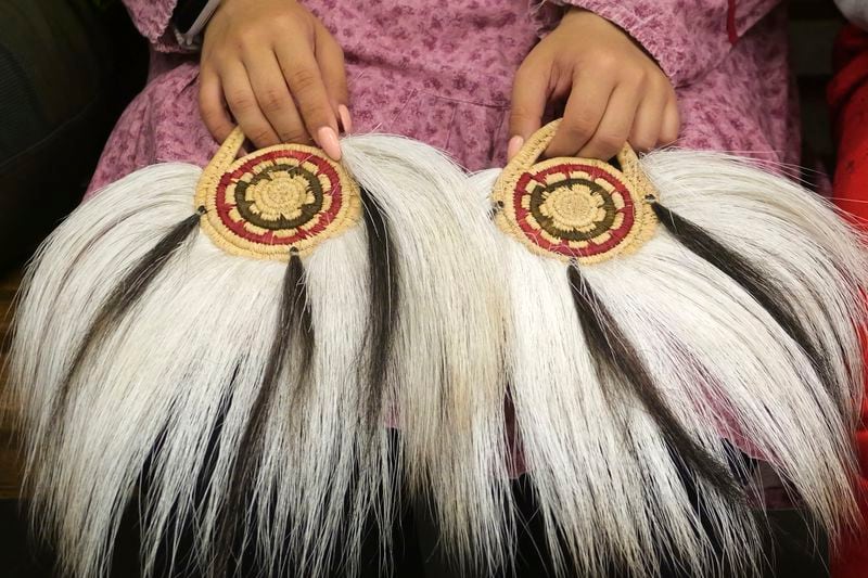 A young girl prepares to participate in an Indigenous drum and dance on Thursday, Aug. 15, 2024, Mertarvik, Alaska. (AP Photo/Rick Bowmer)