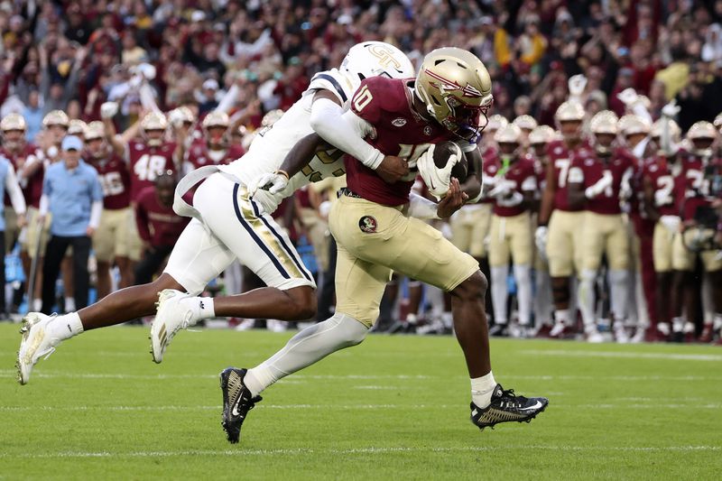 Georgia's Zachary Tobe, left, tackles Florida's DJ Lundy during the NCAA college football game between Georgia Tech and Florida State at the Aviva stadium in Dublin, Saturday, Aug. 24, 2024. (AP Photo/Peter Morrison)