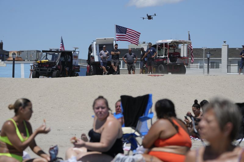 A drone lifts off at Rockaway Beach in New York, Thursday, July 11, 2024. A fleet of drones patrolling New York City’s beaches for signs of sharks and struggling swimmers is drawing backlash from an aggressive group of seaside residents: local shorebirds. Since the drones began flying in May, flocks of birds have repeatedly swarmed the devices, forcing the police department and other city agencies to adjust their flight plans. (AP Photo/Seth Wenig)